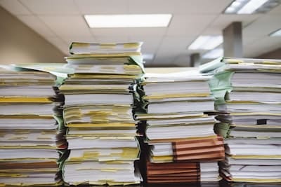 Files stacked for preparation of scanning a document.