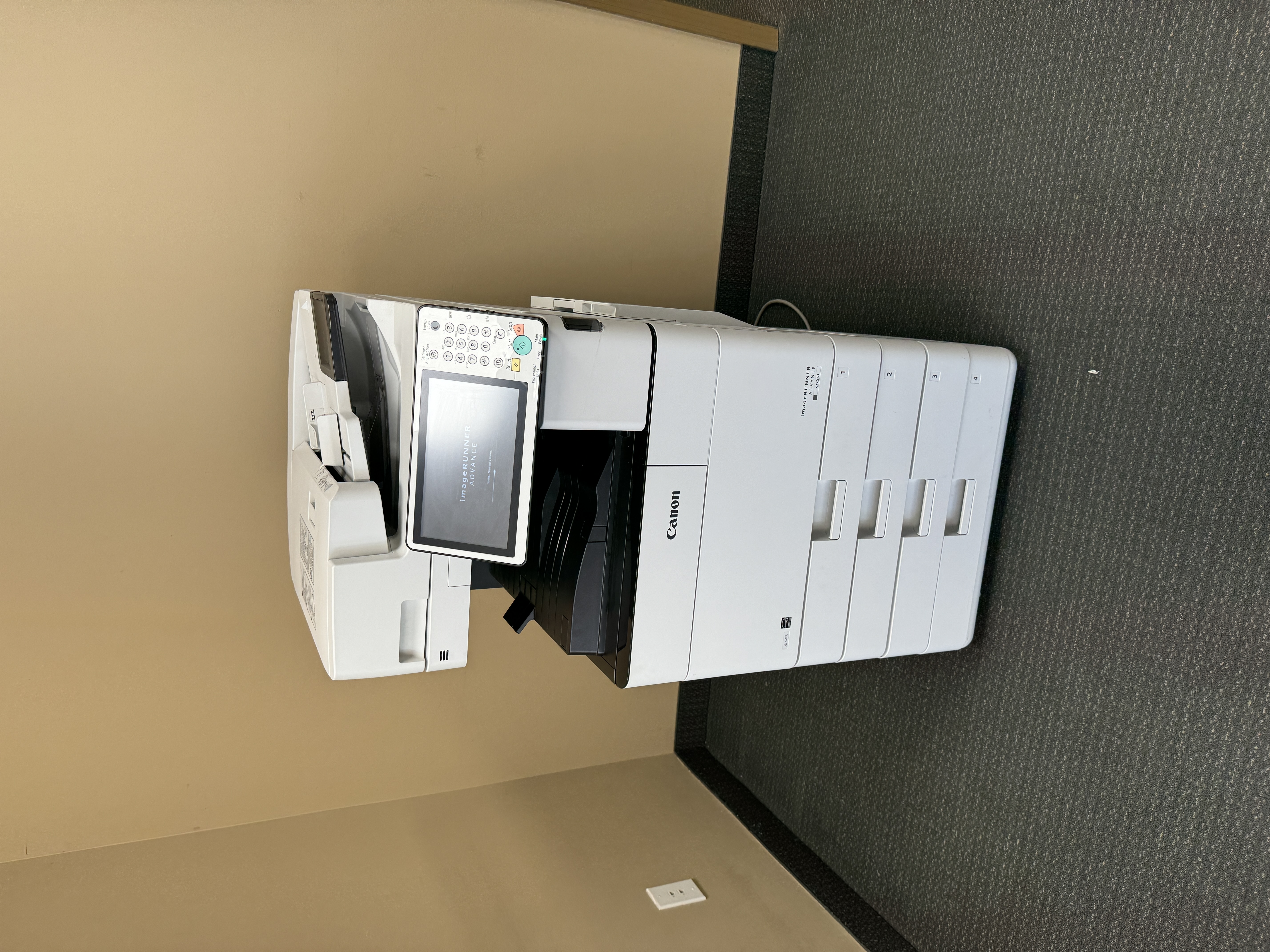 Canon imagerunner advance color copier used in scanning a document.
