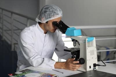 Lab technician working on a microscope